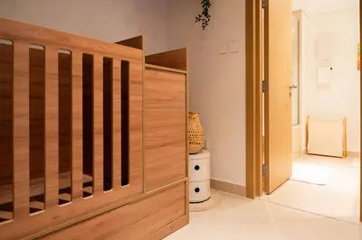 a wooden door in a room with a toilet at Homely Creek Harbour Apartment - Direct Park Access in Dubai