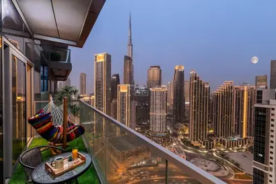 a balcony with a view of a city skyline at Gogoto4 - 2BR High Floor Burj View Infinity Pool PS5 NYE Fireworks View in Dubai