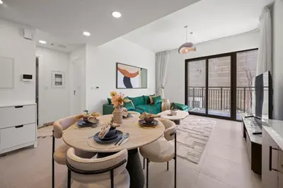 a kitchen and living room with a table and chairs at Luxury 1BR Apartment Dubai in Dubai