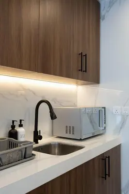 a kitchen with a sink and a microwave at Luxury 1BR Apartment Dubai in Dubai