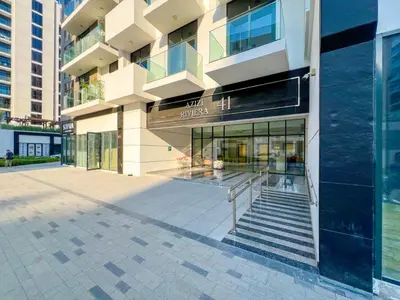 a large building with stairs in front of it at Stylish Apartments in a Vibrant Community in Dubai