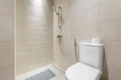 a bathroom with a toilet and a shower at Stylish Apartments in a Vibrant Community in Dubai