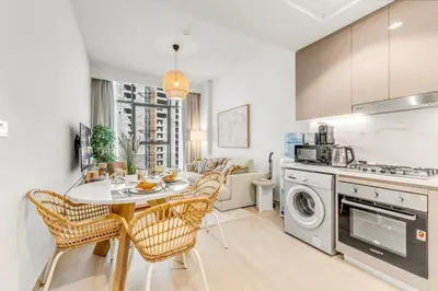 a kitchen and dining room with a table and chairs at Stylish Apartments in a Vibrant Community in Dubai