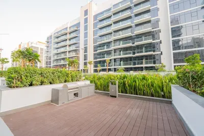 a balcony with a large building in the background at Modern Studio Retreat in Dubai in Dubai