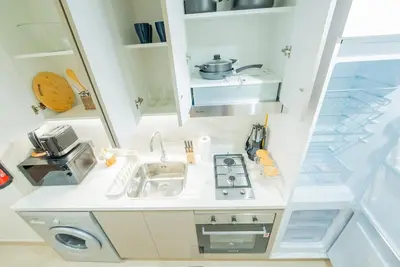 a small kitchen with a sink and a stove at Modern Studio Retreat in Dubai in Dubai