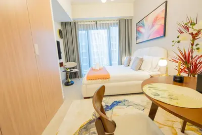 a hotel room with a bed and a table at Modern Studio Retreat in Dubai in Dubai