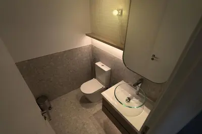 a small bathroom with a toilet and a sink at Spacious 3BR in Sobha Hartland near Downtown in Dubai