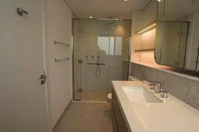 a bathroom with a shower and a sink and a mirror at Spacious 3BR in Sobha Hartland near Downtown in Dubai