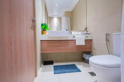 a bathroom with a sink and a toilet at Stunning Studio with Swimming Pool View in Dubai