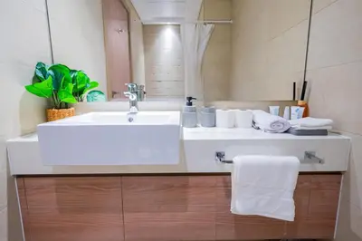 a bathroom with a white sink and a mirror at Stunning Studio with Swimming Pool View in Dubai