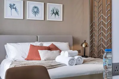 a bedroom with a bed with towels on it at Canal View & High Floor & Valet in Dubai