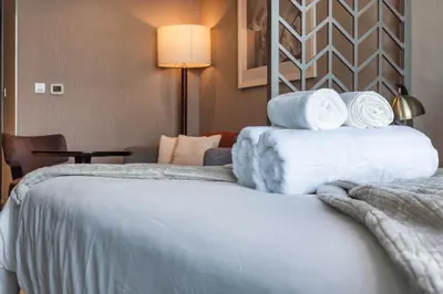 a hotel room with two beds with towels on them at Canal View & High Floor & Valet in Dubai