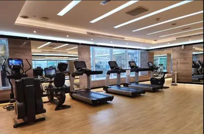 a gym with a bunch of treadmills and elliptical machines at Canal View & High Floor & Valet in Dubai