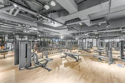 a gym with a lot of treadmills and machines at 1 Bedroom Dream Stay- Binghatti in Dubai