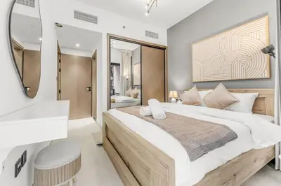 a bedroom with a large bed and a bathroom at 1 Bedroom Dream Stay- Binghatti in Dubai