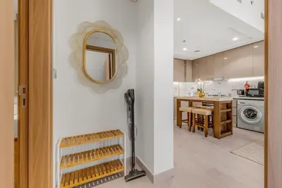 a kitchen with a table and a mirror on the wall at 1-Bedroom Oasis with Views in Dubai