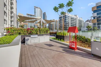 a view of a balcony of a building with a red sign at 1-Bedroom Oasis with Views in Dubai