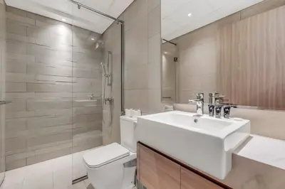 a bathroom with a sink and a toilet and a shower at 1-Bedroom Oasis with Views in Dubai