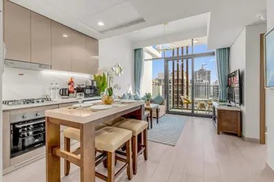 a kitchen with a table and chairs and a large window at 1-Bedroom Oasis with Views in Dubai