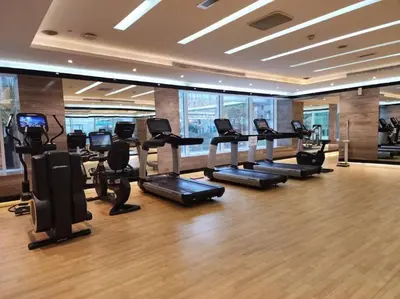 a gym with treadmills and elliptical machines at Luxury Studio close to Dubai Mall and Burj Khalifa in Dubai
