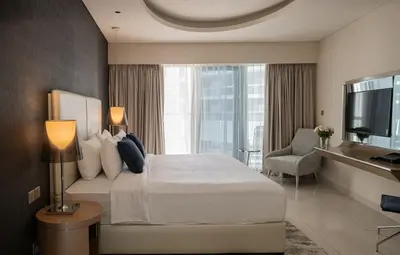 a hotel room with a bed and a television at Stylish 1BR in Damac by Paramount Business Bay in Dubai