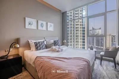a bedroom with a large bed and a large window at Waterfront Studio in Business Bay near Burj Khalifa in Dubai