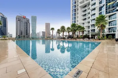 a swimming pool in the middle of a city with tall buildings at Waterfront Studio in Business Bay near Burj Khalifa in Dubai