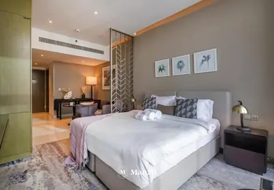 a bedroom with a large bed with two teddy bears on it at Waterfront Studio in Business Bay near Burj Khalifa in Dubai
