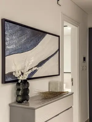 a television on a wall in a living room at Amazing Brand New 1BR in Dubai