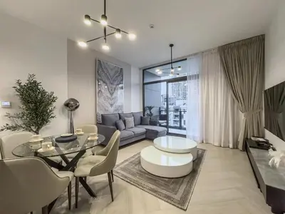 a living room with a couch and a table at Amazing Brand New 1BR in Dubai