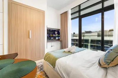 a bedroom with a large bed and a large window at Stylish City Studio with Burj Khalifa View in Dubai