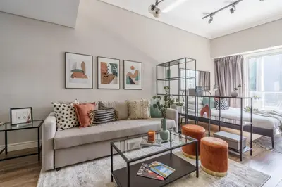 a living room with a couch and a table at GuestReady Holiday Homes - Industrial Chic in Dubai