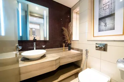 a bathroom with a sink and a toilet at High Floor Burj Khalifa View Luxurious 1BR in Dubai