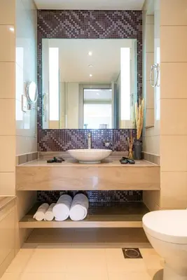 a bathroom with a sink and a mirror at High Floor Burj Khalifa View Luxurious 1BR in Dubai