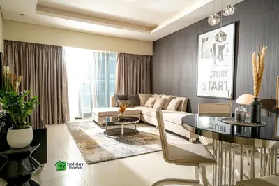a living room with a couch and a table at High Floor Burj Khalifa View Luxurious 1BR in Dubai