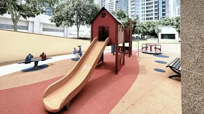 a playground with a slide in a park at Blakely Tower, Park Island, Dubai Marina - Mint Stay in Dubai