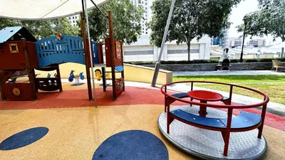 a playground in a park with a play equipment at Blakely Tower, Park Island, Dubai Marina - Mint Stay in Dubai