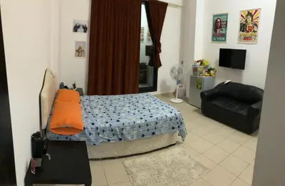 a bedroom with a bed and a couch in it at Al Barsha Hostel for Girls in Dubai