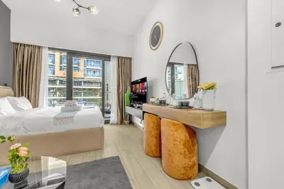 a bedroom with a bed and a mirror at Studio in Azizi with Free Pool and Gym Access in Dubai