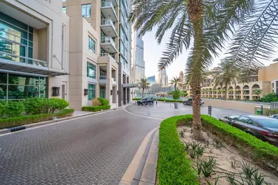 a palm tree on a street in a city at Studio in Azizi with Free Pool and Gym Access in Dubai