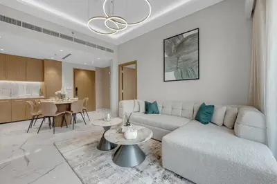 a living room with a couch and a table at 2BR Guest Favorite Elegant Apartment at Riviera 67 in Dubai