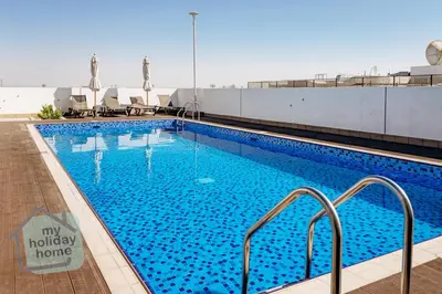 a large swimming pool on top of a building at Exclusive 2BR With City View Pool & Gym Access in Dubai