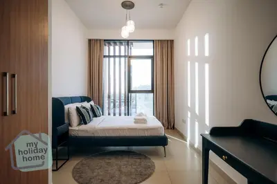 a small bedroom with a bed and a window at Exclusive 2BR With City View Pool & Gym Access in Dubai