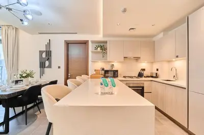 a kitchen and dining room with a table and chairs at FAM Living -Bright & Spacious Home in Sobha Hartland in Dubai