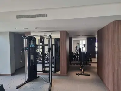 a gym with several treadmills and weights at FAM Living -Bright & Spacious Home in Sobha Hartland in Dubai