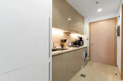 a kitchen with a sink and a door leading into a room at Exclusive Downtown Dubai Studio in Dubai