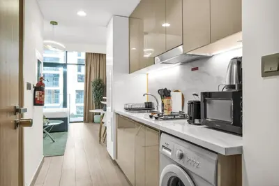 a kitchen with a sink and a dishwasher at Exclusive Downtown Dubai Studio in Dubai
