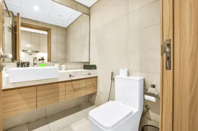 a bathroom with a white toilet and a sink at Exclusive Downtown Dubai Studio in Dubai