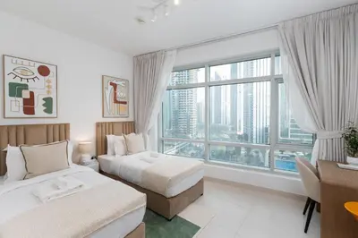 a hotel room with two beds and a large window at The Lofts West, Downtown Dubai - Mint Stay in Dubai