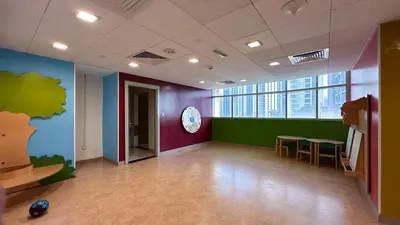 an empty room with a table and a clock on the wall at The Lofts West, Downtown Dubai - Mint Stay in Dubai